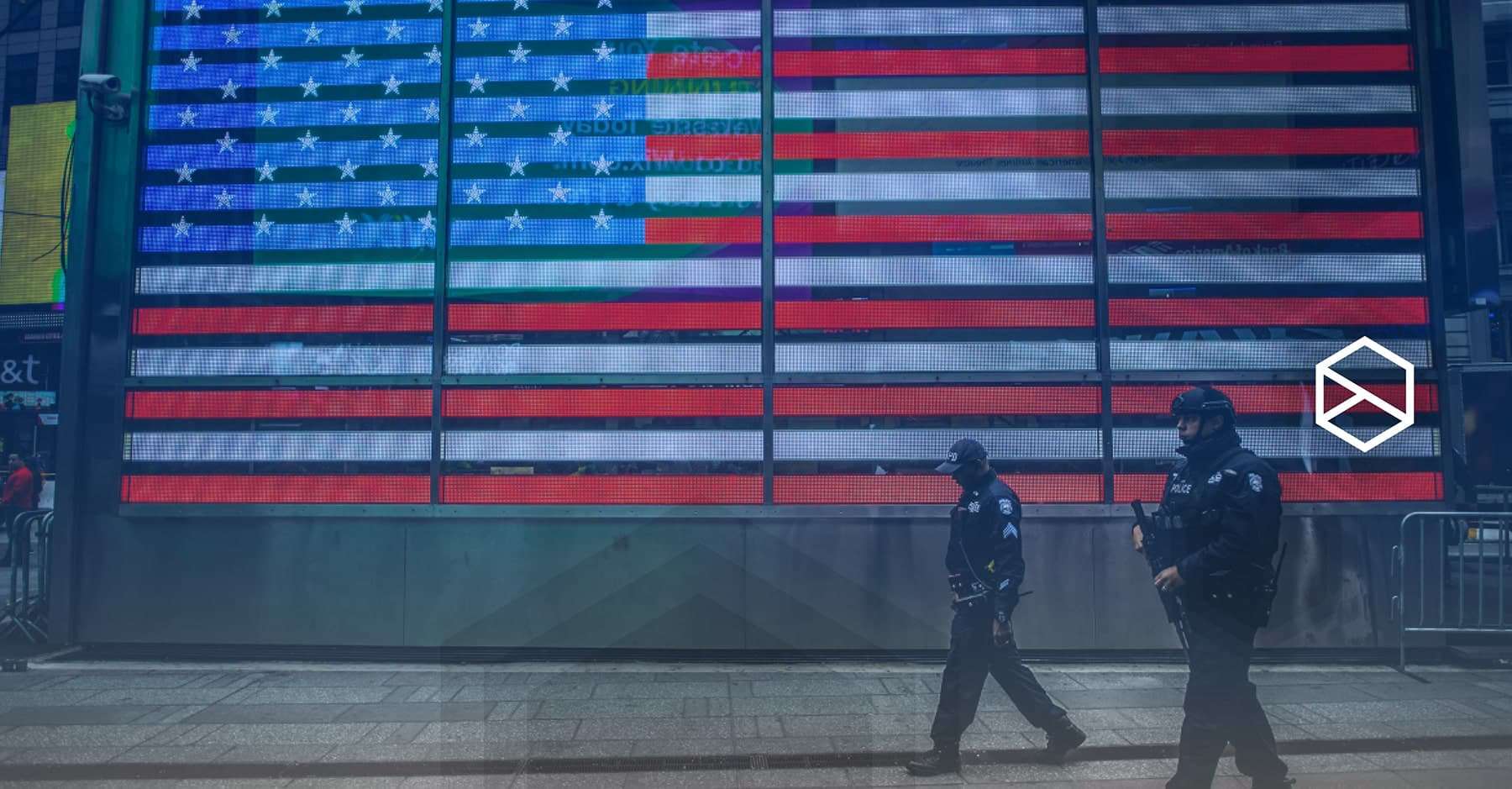 American flag with with two security guards walking past